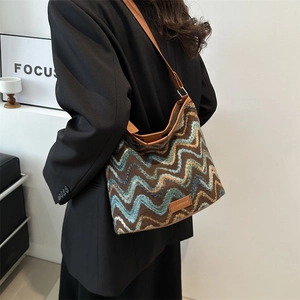 Ethnic knit bucket bag with wave pattern and brown leather strap for autumn style