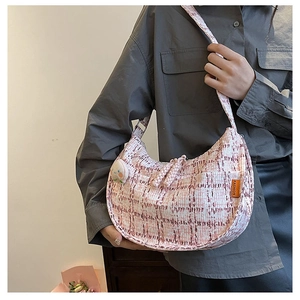 Detailed view of pink plaid hobo bag with fashion label and cute cartoon charm