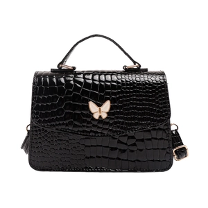 Elegant black crocodile pattern handbag with white butterfly clasp and shoulder strap