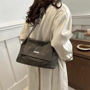 Minimalist charcoal grey chain shoulder bag with metal logo and large flap for daily use