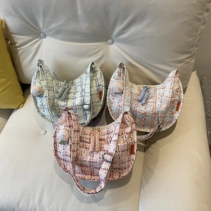 Houndstooth tweed half-moon shoulder bag in pink, blue, and gray with peach charms