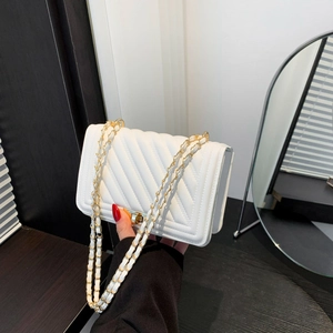 Classic white quilted crossbody bag with gold chain strap and metal lock closure