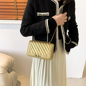 Chic gold quilted crossbody chain bag with rectangular design and metallic finish