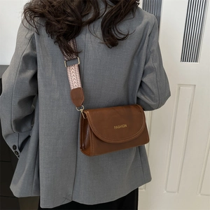 Retro brown leather crossbody bag with vintage wide woven strap and gold fashion lettering