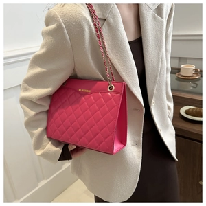 Close-up of rose pink quilted leather texture and gold metal chain strap detail