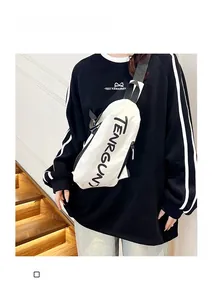Male model wearing a white canvas sports crossbody chest bag with black letter print