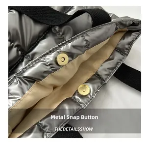 Detail of the magnetic snap closure and silver quilted fabric on this large tote bag