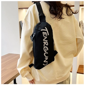 Back view of a black nylon crossbody bag with white TENRGUN lettering on a male model