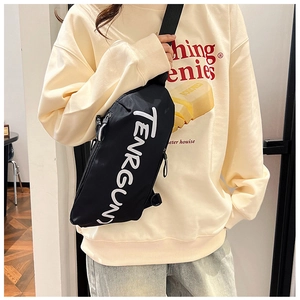Detail of black sporty crossbody bag with white TENRGUN lettering and adjustable strap