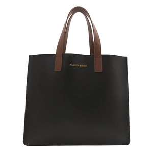 Minimalist black tote briefcase with brown leather handles and gold fashion lettering