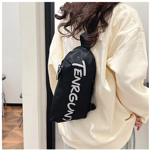 Back view of a black sporty chest bag with white TENRGUN text worn by a male model