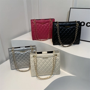 Chic quilted tote bags with chain straps in multiple colors on a stylish display stand