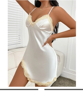 Detailed shot of white satin slip dress with yellow lace trim and side slit detail