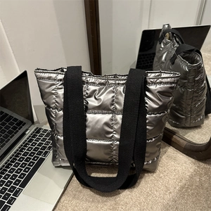 Minimalist silver quilted down tote bag with black nylon straps for daily winter commute