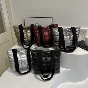 Quilted down metallic tote bags in five colors on a white display stand for winter