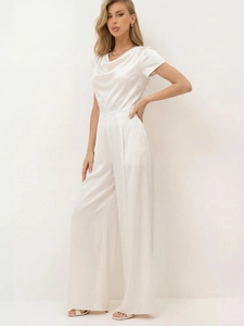 Detail view of elegant cowl neck and silky satin texture on white wide-leg jumpsuit