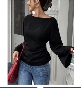 Detail of elegant black off-the-shoulder top with stylish long flared sleeves