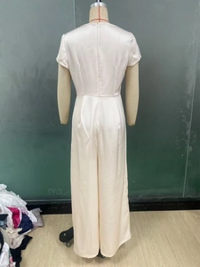 Back view of elegant white satin jumpsuit featuring a high waist and rear zipper closure