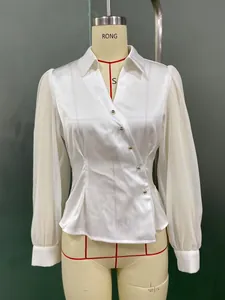 Detail of white satin blouse with chiffon lantern sleeves and buttoned waist tailoring