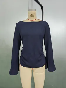 Detail of dark blue flare sleeve top with elegant boat neck and textured fabric