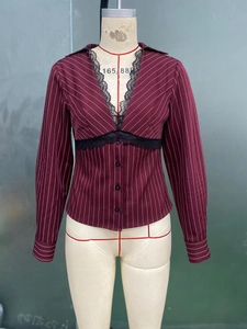 Close-up of burgundy striped shirt featuring black lace trim and small round buttons