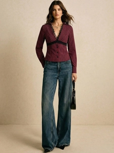Detail of burgundy striped shirt with black lace trim V-neck and long sleeves