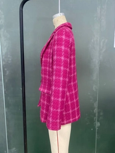 Detail of pink plaid tweed mid-length blazer jacket showing textured weave and side profile