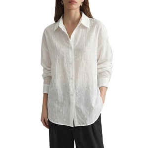 Women's white long sleeve button down shirt with textured fabric and a loose casual fit