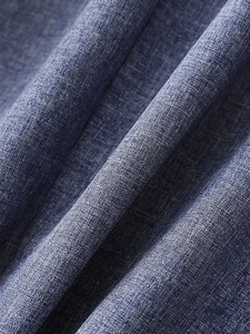 Macro shot of dark blue textured fabric showing fiber details on casual blazer jacket