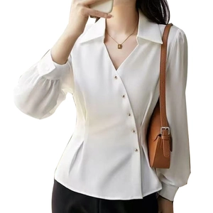 Elegant white satin long sleeve blouse featuring asymmetrical gold buttons and V-neckline