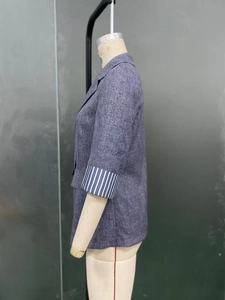 Detail of navy blue blazer with chic striped sleeve cuffs on a mannequin