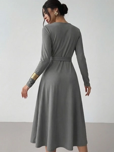 Elegant grey long sleeve A-line knit dress with waist belt and minimalist silhouette