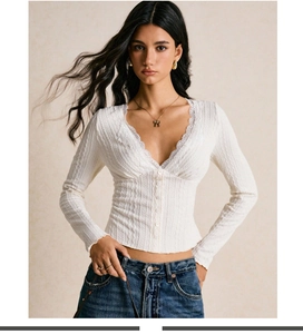 Detail of white slim-fit knit top with elegant lace V-neckline and ribbed texture