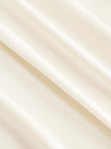 Close-up of soft cream knit fabric texture with natural folds for thermal shirts