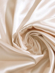 Detailed view of champagne satin fabric with soft silk texture and elegant draping