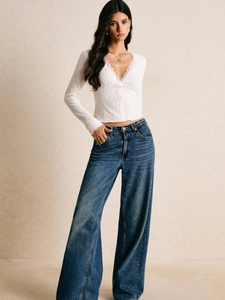 Women's white V-neck long sleeve top with lace trim and high waist wide leg jeans