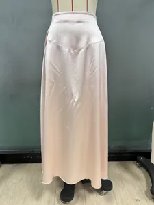 Detail view of V-shaped waist seam on silky pale pink satin long skirt on a mannequin