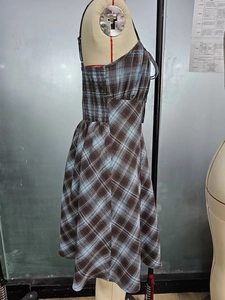 Detail view of the side elastic drawstring ruching on plaid bodycon slip dress