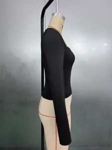 Side view of black slim fit square neck long sleeve top showing tight stretch fabric