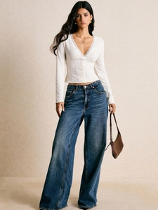 White long-sleeve V-neck waffle knit top with lace trim and high-waist wide-leg jeans