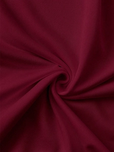 Macro shot of deep burgundy knit fabric texture with elegant spiral fold patterns