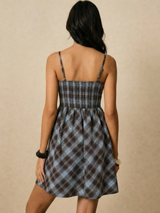 Detail of blue and brown plaid mini dress with elastic smocking back design