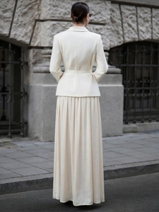 Elegant cream white blazer and long pleated skirt suit set with belt seen from the back
