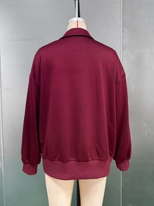 Back view of burgundy oversized sweatshirt featuring ribbed cuffs and a polo collar