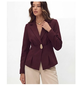 Detail of burgundy blazer showing unique gold button and slimming waist pleats