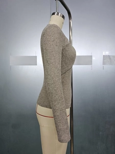 Detail of cross-wrap front design on a slim fit ribbed knit sweater in charcoal grey