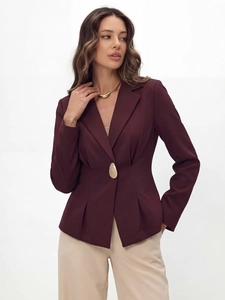 Detail of burgundy blazer showing tailored waist and a unique gold pebble button