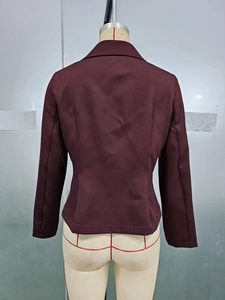 Rear view of a slim-fit burgundy blazer for women showing back seams and tailored cut