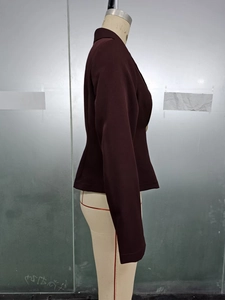 Side view of a slim-fit burgundy blazer jacket on a mannequin for women's fashion