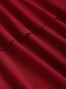 Dettaglio della trama in maglia rosso scuro con eleganti pieghe drappeggiate